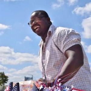 Man smiling against blue sky